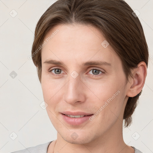 Joyful white young-adult female with short  brown hair and grey eyes