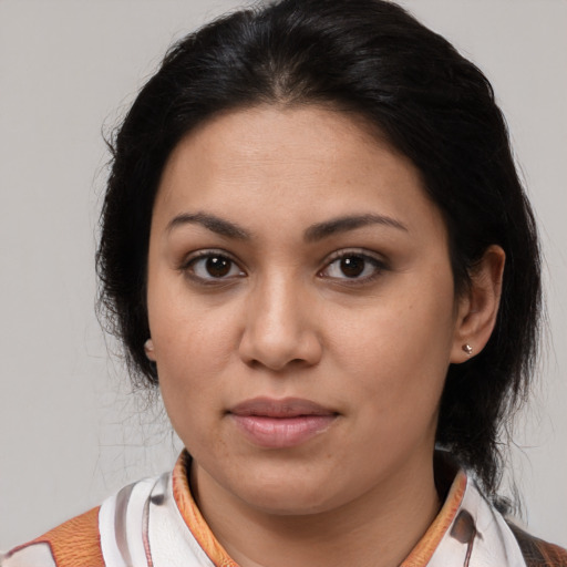 Joyful latino young-adult female with medium  brown hair and brown eyes