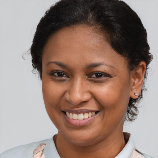 Joyful black young-adult female with medium  brown hair and brown eyes