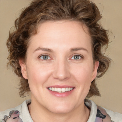 Joyful white young-adult female with medium  brown hair and blue eyes