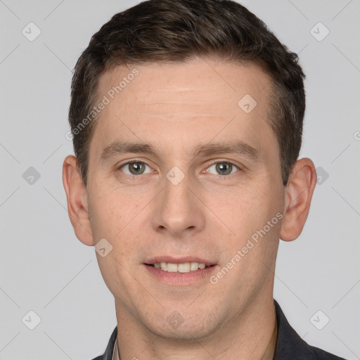 Joyful white young-adult male with short  brown hair and grey eyes