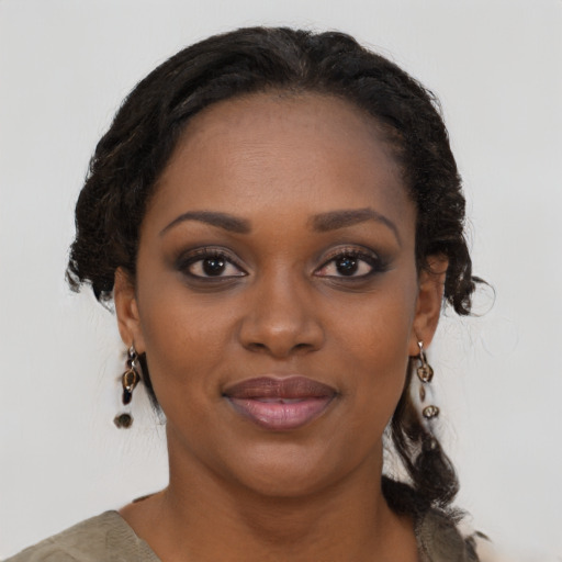Joyful black young-adult female with medium  black hair and brown eyes