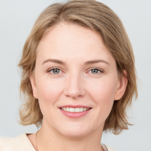 Joyful white young-adult female with medium  brown hair and blue eyes