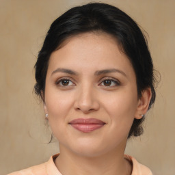 Joyful latino young-adult female with medium  brown hair and brown eyes