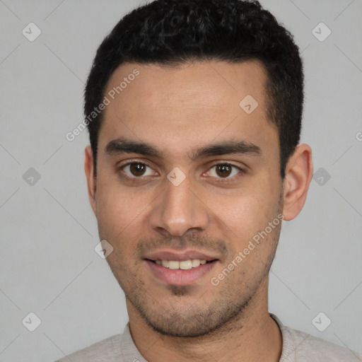 Joyful white young-adult male with short  black hair and brown eyes