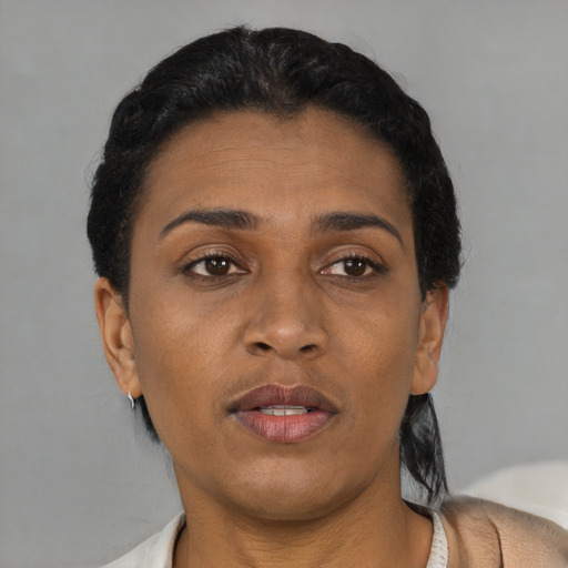 Joyful black adult female with short  brown hair and brown eyes
