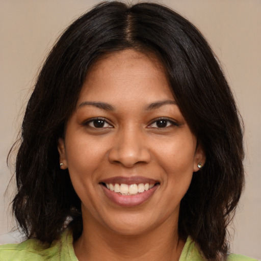 Joyful black young-adult female with medium  brown hair and brown eyes