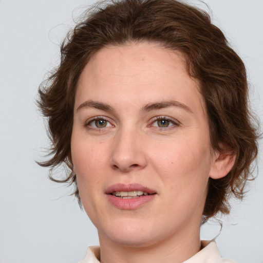 Joyful white young-adult female with medium  brown hair and green eyes