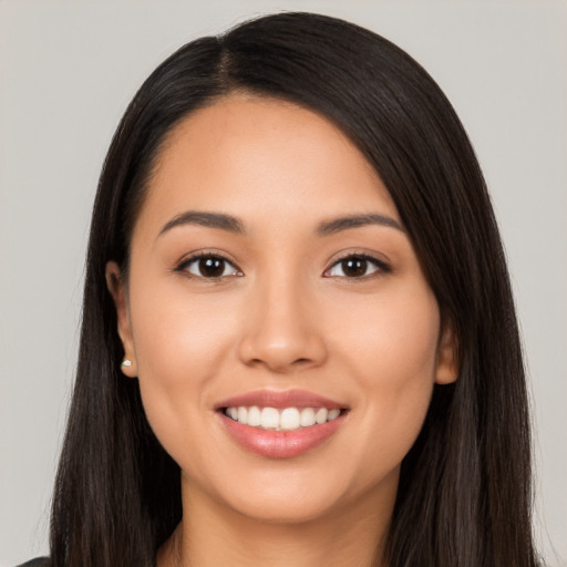 Joyful latino young-adult female with long  black hair and brown eyes