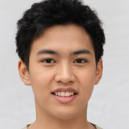 Joyful asian young-adult male with short  brown hair and brown eyes