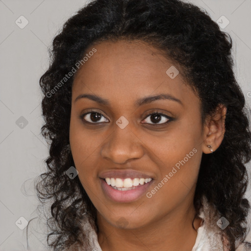 Joyful black young-adult female with long  brown hair and brown eyes