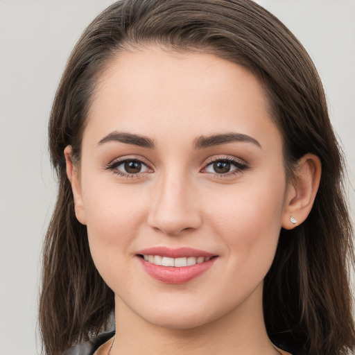 Joyful white young-adult female with long  brown hair and brown eyes