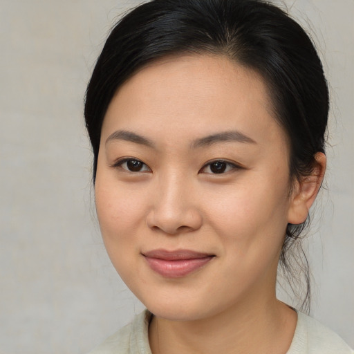 Joyful asian young-adult female with medium  brown hair and brown eyes