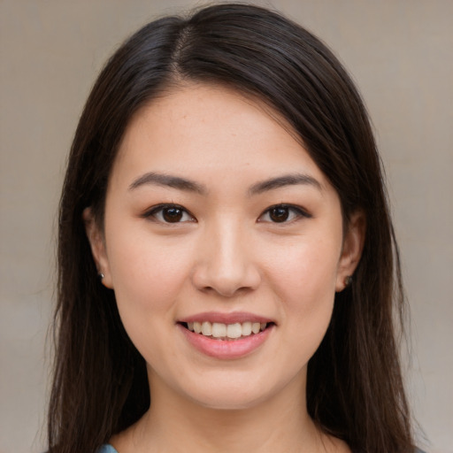 Joyful white young-adult female with long  brown hair and brown eyes