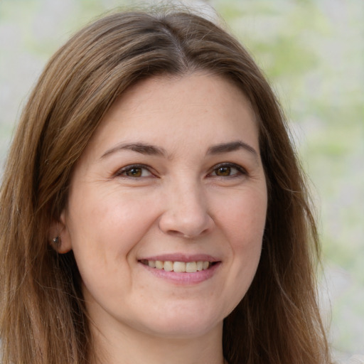 Joyful white young-adult female with long  brown hair and green eyes