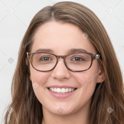 Joyful white young-adult female with long  brown hair and blue eyes