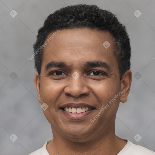 Joyful black young-adult male with short  black hair and brown eyes