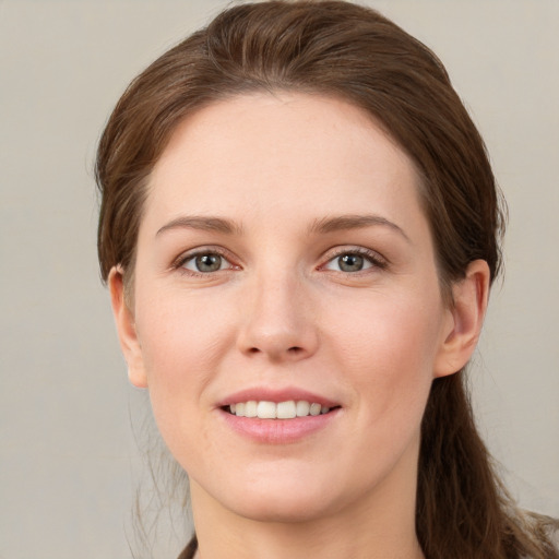 Joyful white young-adult female with medium  brown hair and grey eyes