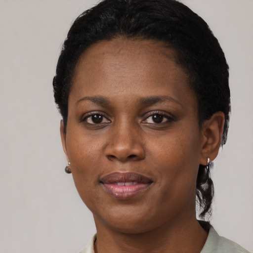 Joyful black young-adult female with short  brown hair and brown eyes