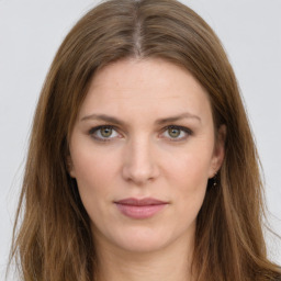 Joyful white young-adult female with long  brown hair and green eyes