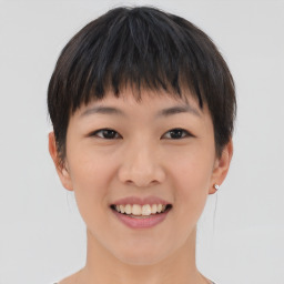 Joyful asian young-adult female with short  brown hair and brown eyes