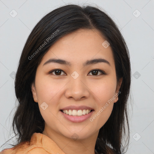 Joyful latino young-adult female with long  brown hair and brown eyes