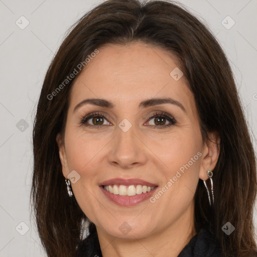 Joyful white adult female with long  brown hair and brown eyes