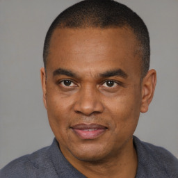 Joyful black adult male with short  brown hair and brown eyes