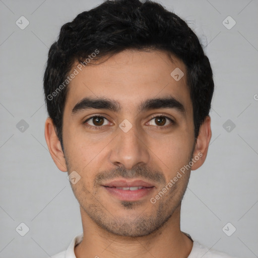 Joyful latino young-adult male with short  black hair and brown eyes