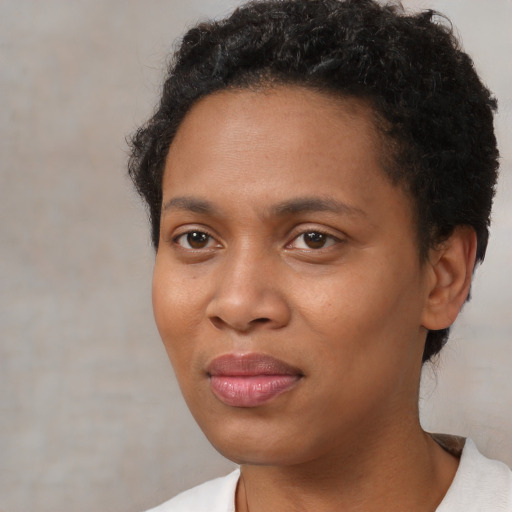 Joyful black young-adult female with short  brown hair and brown eyes
