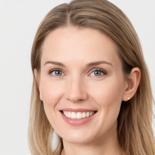 Joyful white young-adult female with long  brown hair and blue eyes