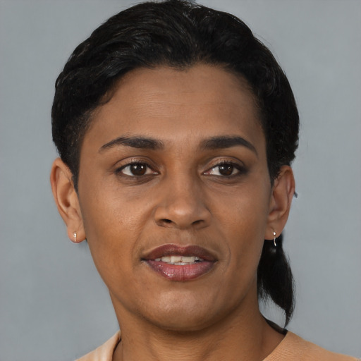 Joyful black young-adult female with short  brown hair and brown eyes