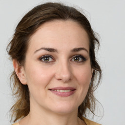 Joyful white young-adult female with medium  brown hair and green eyes