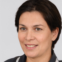 Joyful white adult female with medium  brown hair and brown eyes