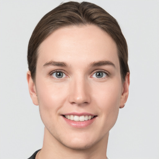 Joyful white young-adult female with short  brown hair and grey eyes