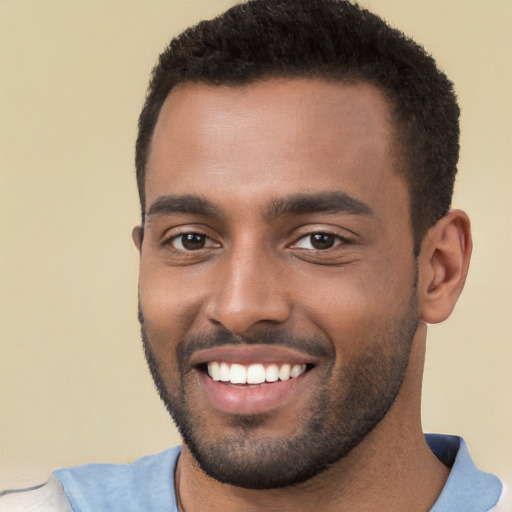 Joyful black young-adult male with short  black hair and brown eyes