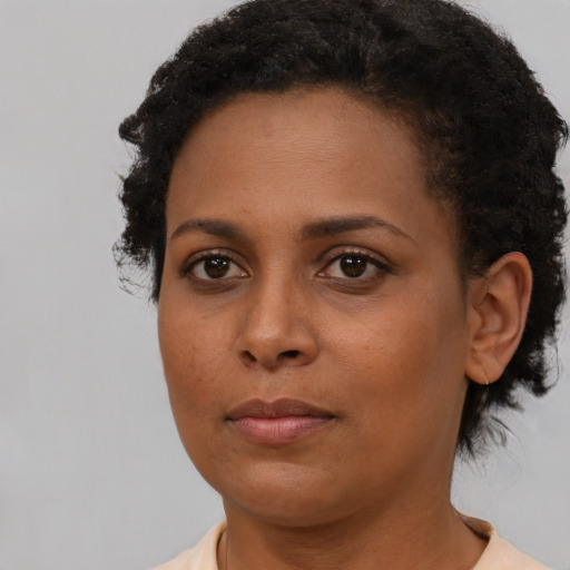 Neutral black young-adult female with short  brown hair and brown eyes