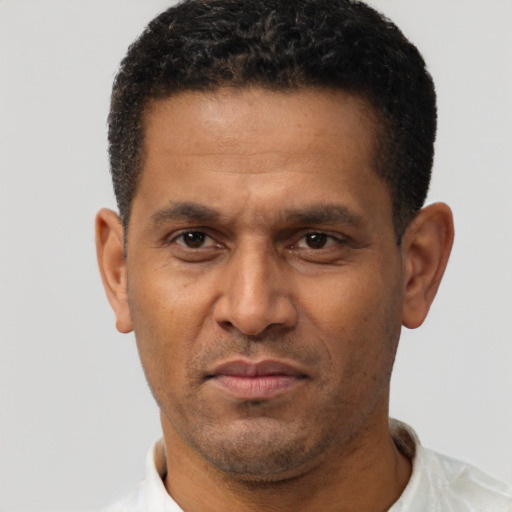 Neutral latino adult male with short  brown hair and brown eyes