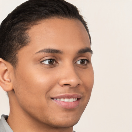 Joyful latino young-adult male with short  brown hair and brown eyes