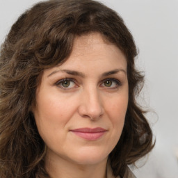 Joyful white young-adult female with medium  brown hair and green eyes