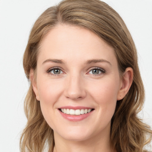 Joyful white young-adult female with long  brown hair and blue eyes