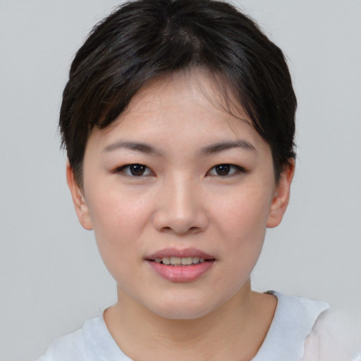 Joyful asian young-adult female with short  brown hair and brown eyes