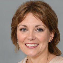 Joyful white adult female with medium  brown hair and grey eyes