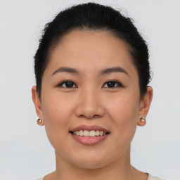 Joyful asian young-adult female with short  brown hair and brown eyes