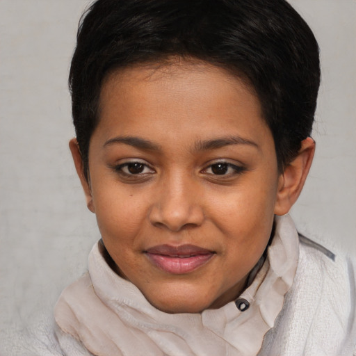 Joyful black child female with short  brown hair and brown eyes