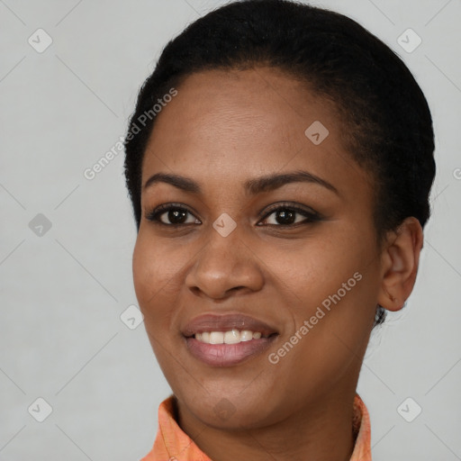 Joyful black young-adult female with short  black hair and brown eyes