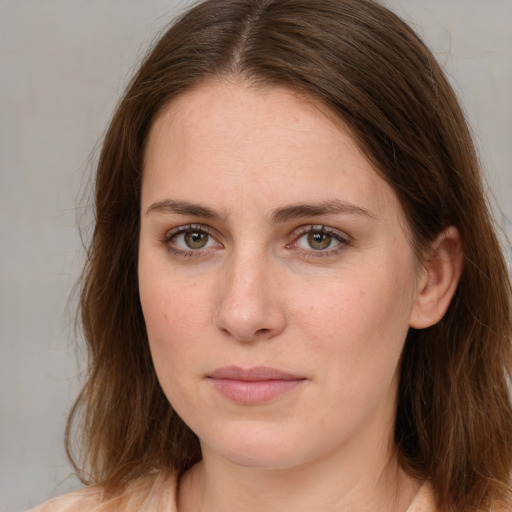 Joyful white young-adult female with medium  brown hair and green eyes