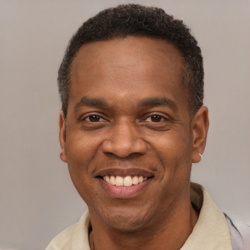 Joyful latino adult male with short  brown hair and brown eyes