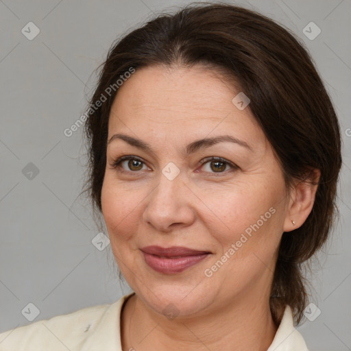 Joyful white adult female with medium  brown hair and brown eyes