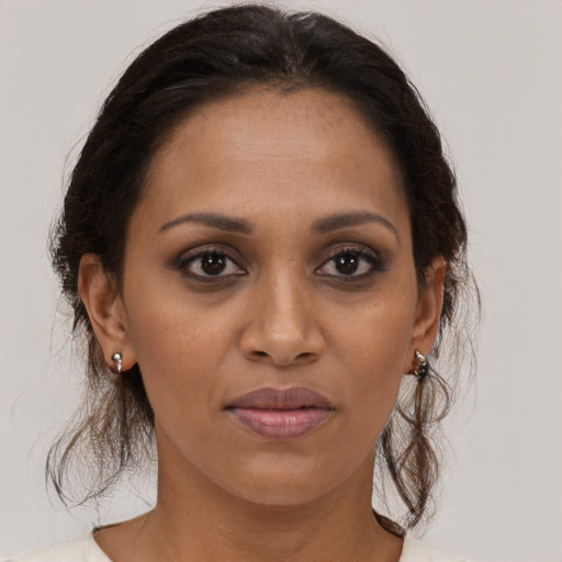 Joyful black adult female with medium  brown hair and brown eyes